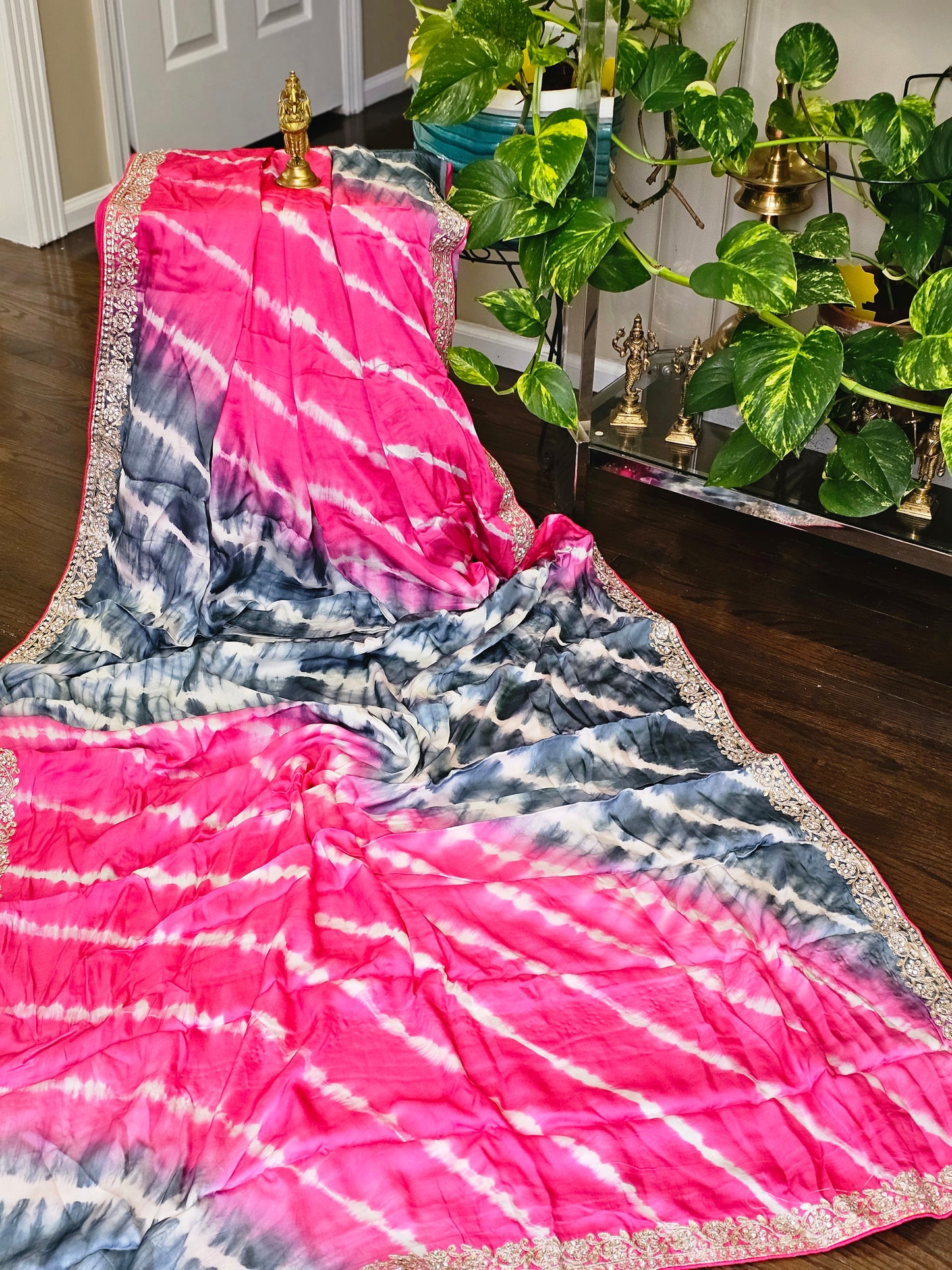 A satin silk with lehari pattern with dual tone along with gotta Patti work along the borders of the saree